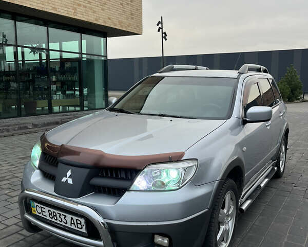 Серый Мицубиси Аутлендер, объемом двигателя 2.38 л и пробегом 180 тыс. км за 6000 $, фото 1 на Automoto.ua