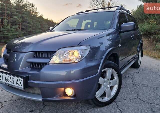 Серый Мицубиси Аутлендер, объемом двигателя 2 л и пробегом 157 тыс. км за 8300 $, фото 1 на Automoto.ua
