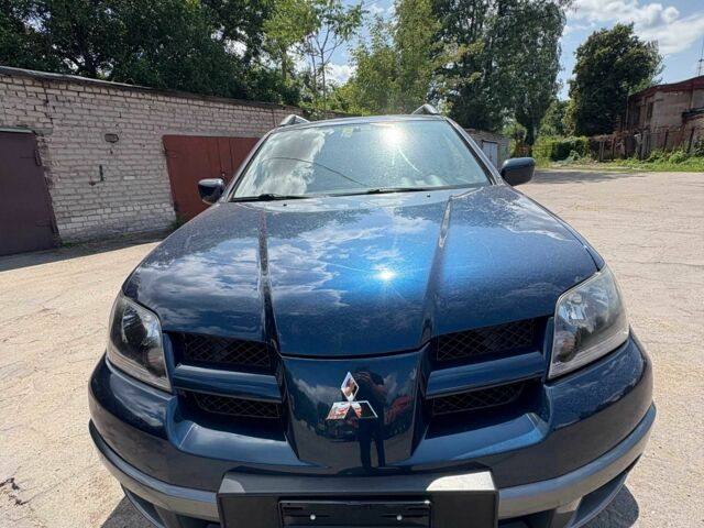 Синий Мицубиси Аутлендер, объемом двигателя 2.4 л и пробегом 172 тыс. км за 4050 $, фото 1 на Automoto.ua