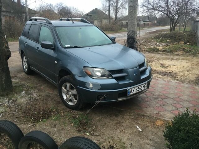 Синий Мицубиси Аутлендер, объемом двигателя 2.4 л и пробегом 218 тыс. км за 3500 $, фото 1 на Automoto.ua