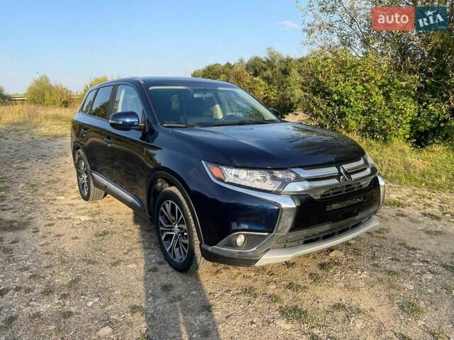 Синий Мицубиси Аутлендер, объемом двигателя 2.4 л и пробегом 221 тыс. км за 12300 $, фото 1 на Automoto.ua