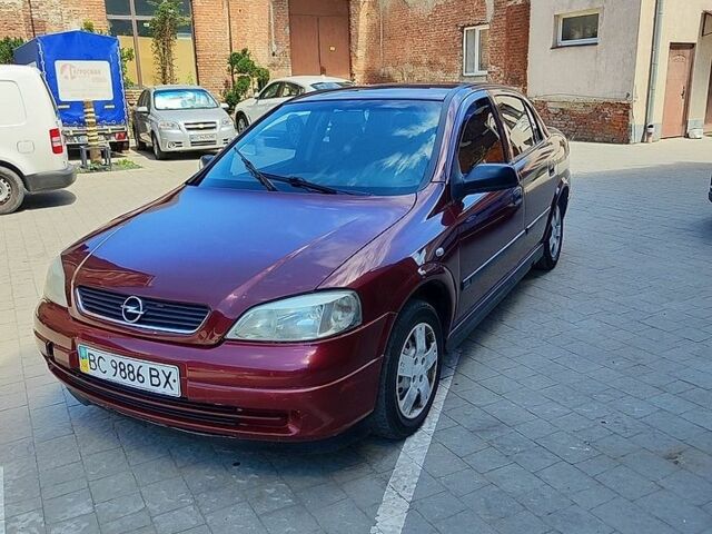 Красный Опель Астра, объемом двигателя 1.39 л и пробегом 180 тыс. км за 1700 $, фото 1 на Automoto.ua