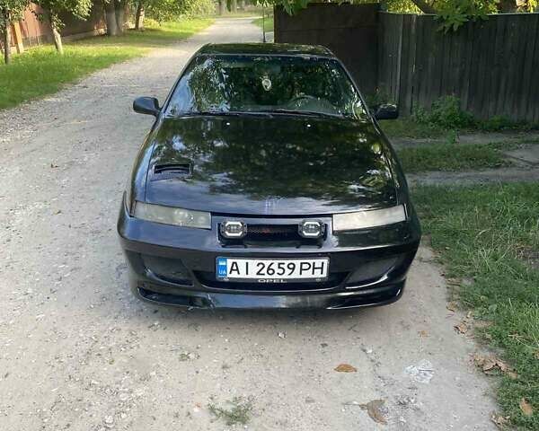 Черный Опель Калибра, объемом двигателя 2 л и пробегом 245 тыс. км за 2900 $, фото 1 на Automoto.ua