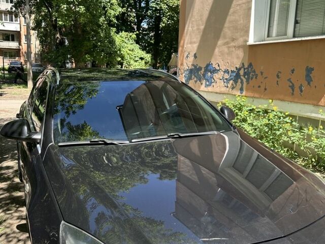 Чорний Опель Інсігнія, об'ємом двигуна 2 л та пробігом 249 тис. км за 7600 $, фото 1 на Automoto.ua