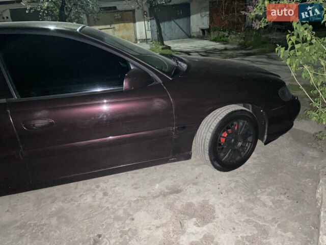 Красный Опель Омега, объемом двигателя 2.2 л и пробегом 286 тыс. км за 3750 $, фото 1 на Automoto.ua