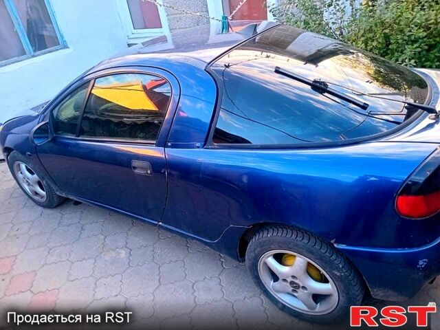 Синий Опель Тигра, объемом двигателя 1.4 л и пробегом 206 тыс. км за 1400 $, фото 1 на Automoto.ua