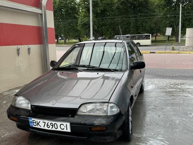 Сірий Сузукі Свифт, об'ємом двигуна 1.3 л та пробігом 300 тис. км за 563 $, фото 1 на Automoto.ua