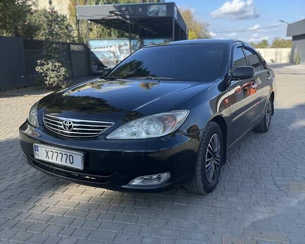 Чорний Тойота Камрі, об'ємом двигуна 2.4 л та пробігом 320 тис. км за 5500 $, фото 1 на Automoto.ua