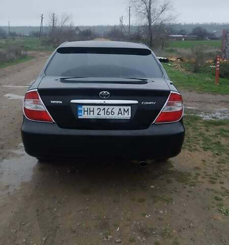 Черный Тойота Камри, объемом двигателя 2.4 л и пробегом 290 тыс. км за 7000 $, фото 1 на Automoto.ua