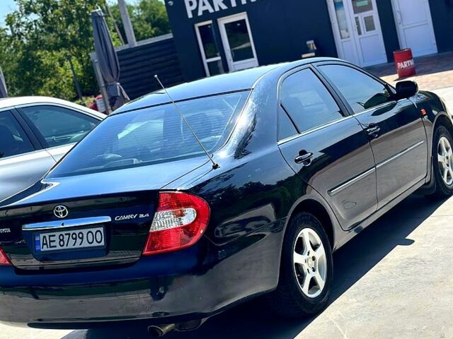 Черный Тойота Камри, объемом двигателя 2.4 л и пробегом 323 тыс. км за 5000 $, фото 1 на Automoto.ua