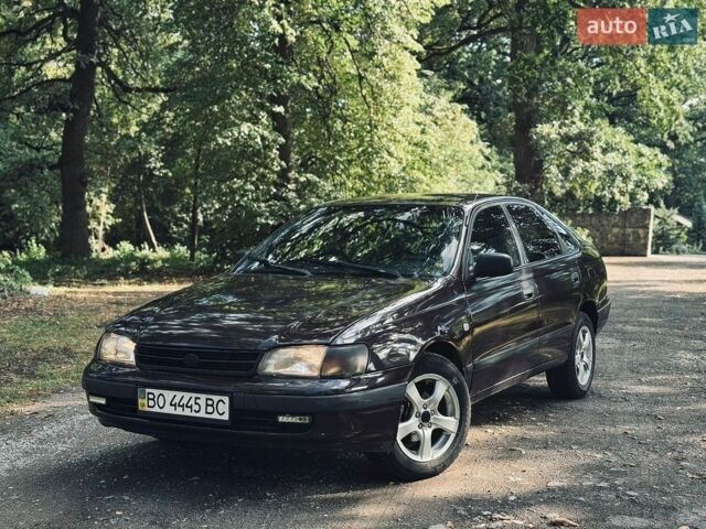 Червоний Тойота Каріна, об'ємом двигуна 1.6 л та пробігом 280 тис. км за 1550 $, фото 1 на Automoto.ua