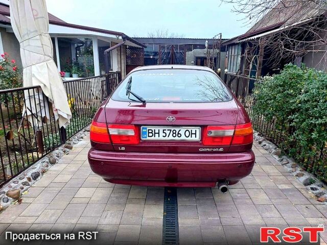 Красный Тойота Карина, объемом двигателя 1.8 л и пробегом 344 тыс. км за 3100 $, фото 1 на Automoto.ua