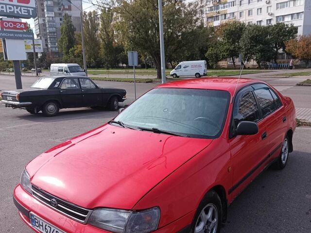 Червоний Тойота Carina E, об'ємом двигуна 2 л та пробігом 290 тис. км за 2300 $, фото 1 на Automoto.ua