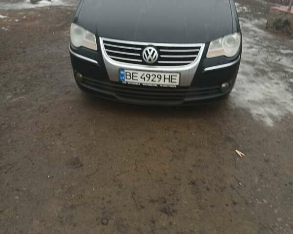 Черный Фольксваген Туран, объемом двигателя 1.4 л и пробегом 212 тыс. км за 7100 $, фото 1 на Automoto.ua