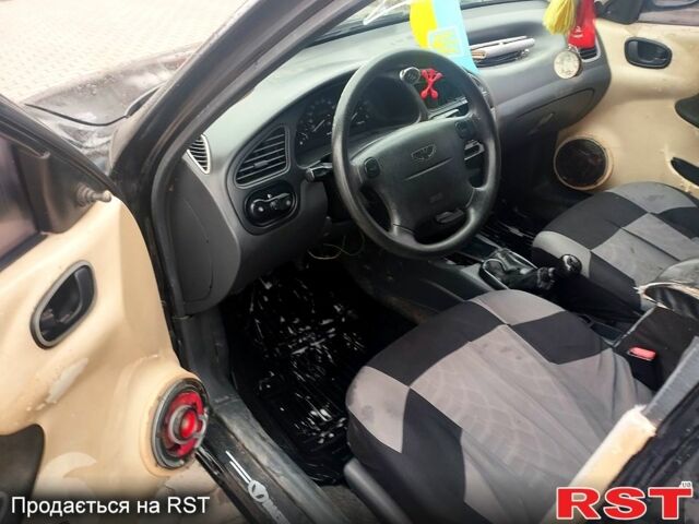 Черный Дэу Ланос, объемом двигателя 1.6 л и пробегом 200 тыс. км за 1600 $, фото 6 на Automoto.ua