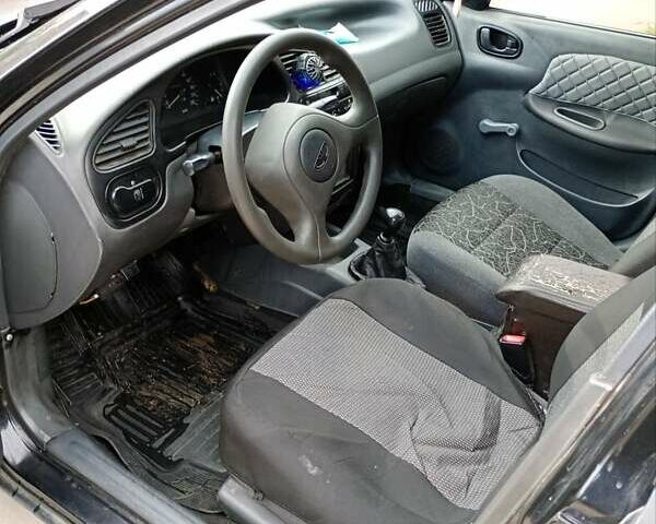 Черный Дэу Ланос, объемом двигателя 1.5 л и пробегом 310 тыс. км за 1700 $, фото 1 на Automoto.ua