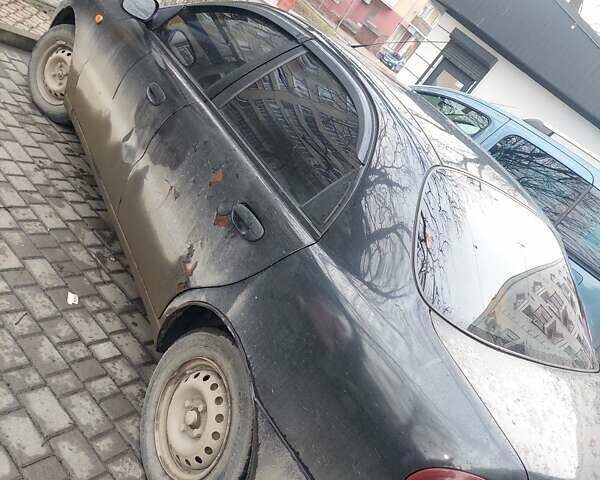 Чорний Деу Ланос, об'ємом двигуна 1.39 л та пробігом 320 тис. км за 1500 $, фото 5 на Automoto.ua