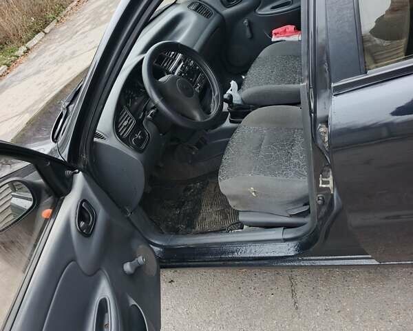Черный Дэу Ланос, объемом двигателя 1.5 л и пробегом 240 тыс. км за 1800 $, фото 1 на Automoto.ua