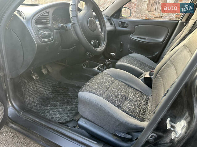 Черный Дэу Ланос, объемом двигателя 1.4 л и пробегом 220 тыс. км за 1450 $, фото 7 на Automoto.ua