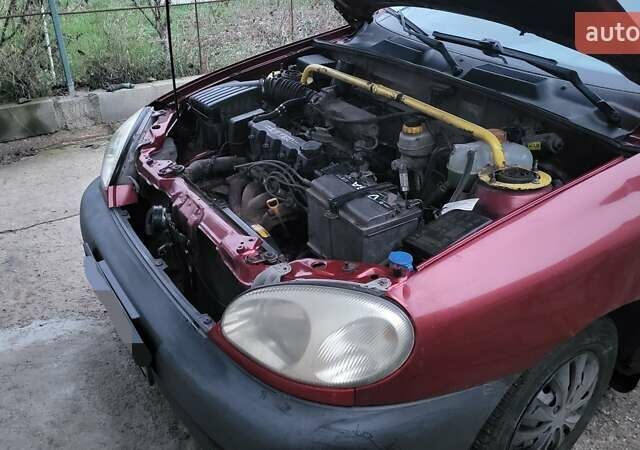 Красный Дэу Ланос, объемом двигателя 1.5 л и пробегом 305 тыс. км за 1800 $, фото 6 на Automoto.ua