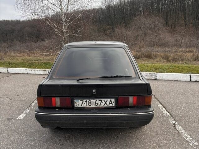 Черный Форд Эскорт, объемом двигателя 1.3 л и пробегом 300 тыс. км за 1000 $, фото 1 на Automoto.ua