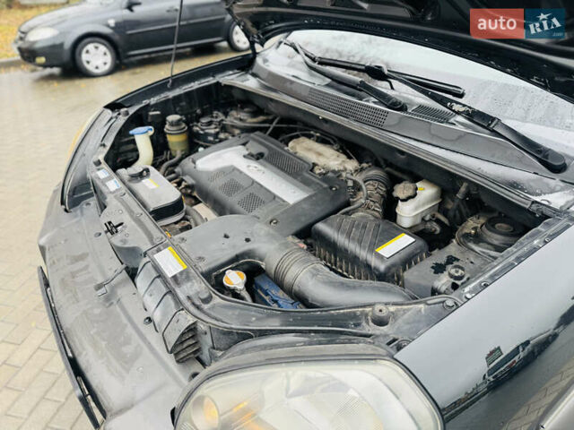 Черный Хендай Туксон, объемом двигателя 1.98 л и пробегом 252 тыс. км за 7300 $, фото 27 на Automoto.ua