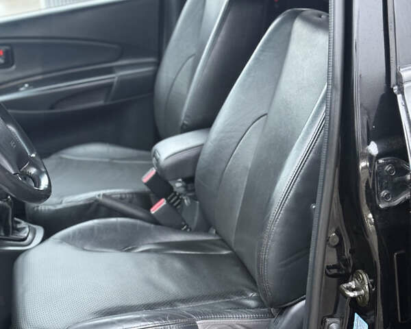 Черный Хендай Туксон, объемом двигателя 1.98 л и пробегом 231 тыс. км за 7750 $, фото 26 на Automoto.ua