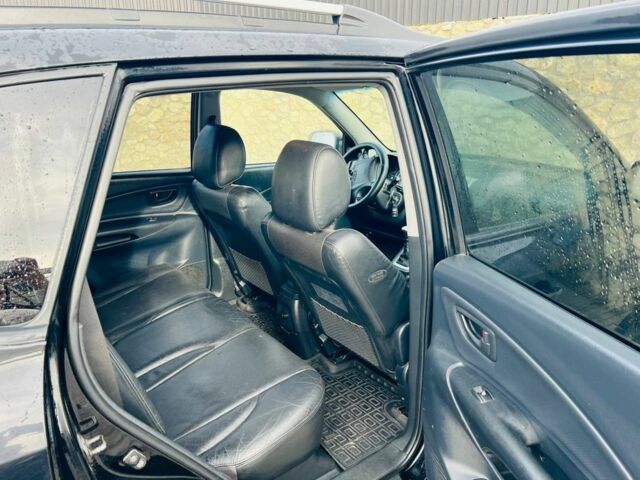 Черный Хендай Туксон, объемом двигателя 2 л и пробегом 310 тыс. км за 6600 $, фото 6 на Automoto.ua