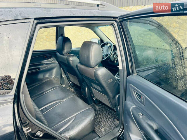 Черный Хендай Туксон, объемом двигателя 1.99 л и пробегом 310 тыс. км за 6600 $, фото 7 на Automoto.ua