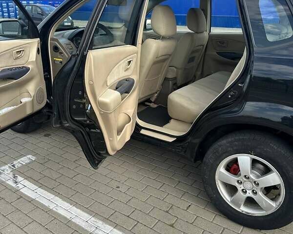 Черный Хендай Туксон, объемом двигателя 1.98 л и пробегом 277 тыс. км за 5350 $, фото 7 на Automoto.ua