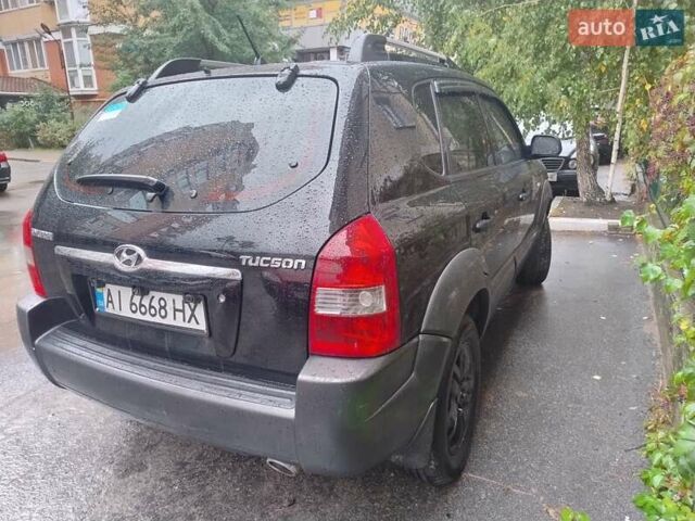 Черный Хендай Туксон, объемом двигателя 1.98 л и пробегом 234 тыс. км за 7800 $, фото 6 на Automoto.ua