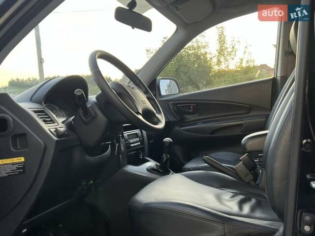 Черный Хендай Туксон, объемом двигателя 1.98 л и пробегом 185 тыс. км за 8500 $, фото 30 на Automoto.ua