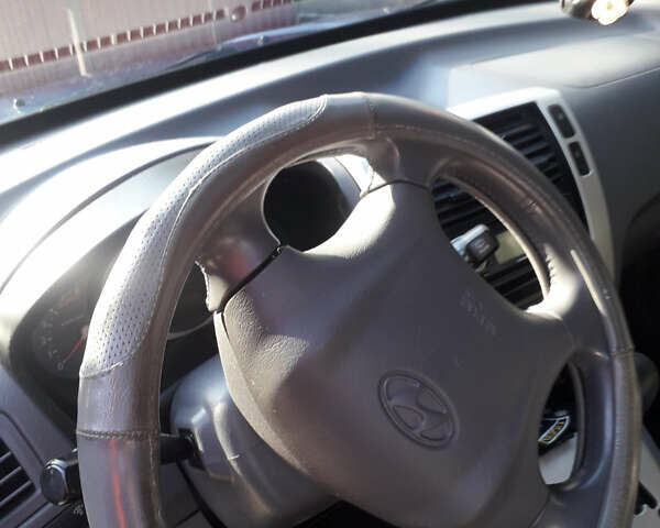 Синий Хендай Туксон, объемом двигателя 2 л и пробегом 223 тыс. км за 7700 $, фото 7 на Automoto.ua