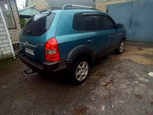Синий Хендай Туксон, объемом двигателя 2 л и пробегом 210 тыс. км за 7550 $, фото 2 на Automoto.ua