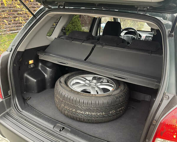 Зеленый Хендай Туксон, объемом двигателя 1.98 л и пробегом 261 тыс. км за 7499 $, фото 124 на Automoto.ua