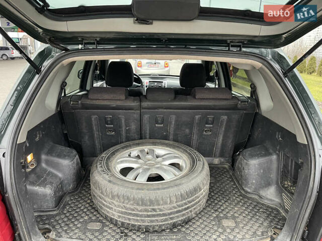 Зеленый Хендай Туксон, объемом двигателя 1.98 л и пробегом 295 тыс. км за 5950 $, фото 19 на Automoto.ua