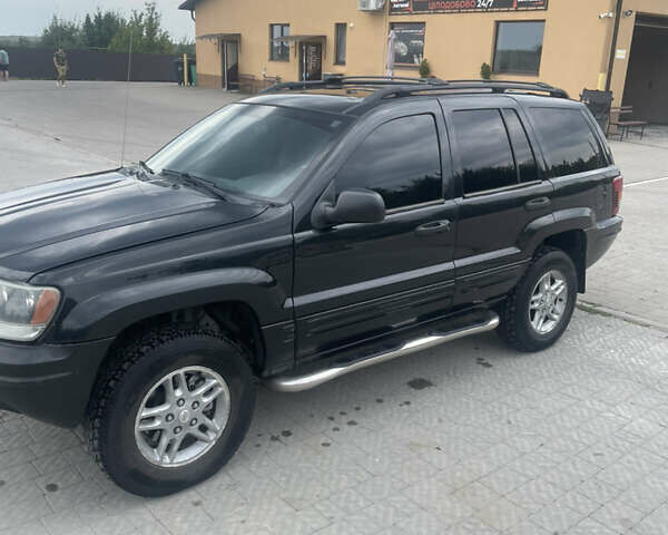 Чорний Джип Grand Cherokee, об'ємом двигуна 4 л та пробігом 125 тис. км за 7000 $, фото 1 на Automoto.ua