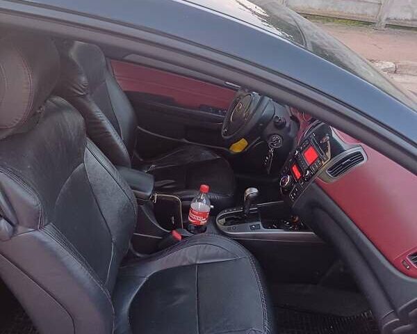 Чорний Кіа Черато, об'ємом двигуна 2 л та пробігом 261 тис. км за 7399 $, фото 7 на Automoto.ua