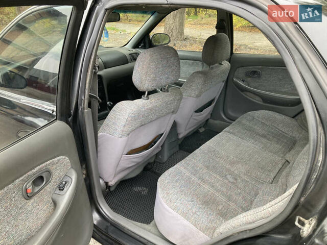 Чорний Кіа Кларус, об'ємом двигуна 2 л та пробігом 493 тис. км за 1850 $, фото 5 на Automoto.ua