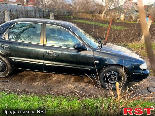 Черный Киа Кларус, объемом двигателя 2 л и пробегом 250 тыс. км за 999 $, фото 1 на Automoto.ua