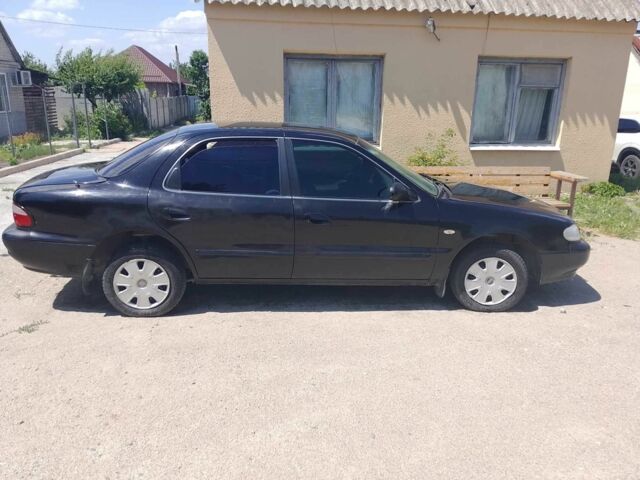Чорний Кіа Кларус, об'ємом двигуна 2 л та пробігом 200 тис. км за 961 $, фото 1 на Automoto.ua