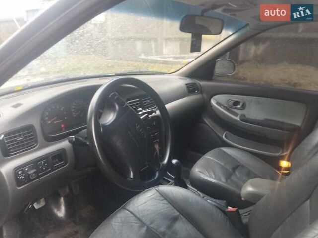Сірий Кіа Кларус, об'ємом двигуна 2 л та пробігом 352 тис. км за 2000 $, фото 13 на Automoto.ua