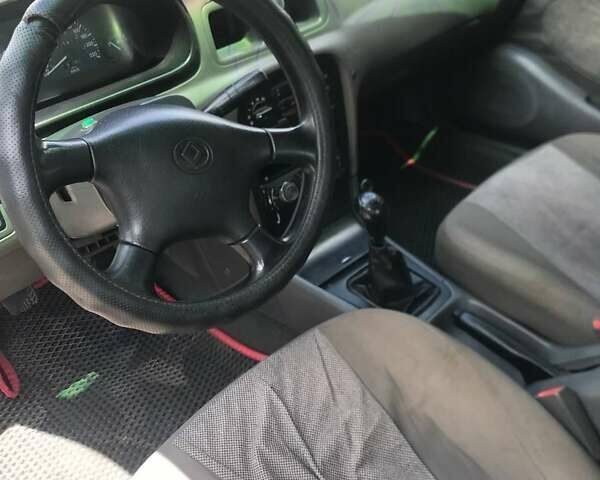 Синий Киа Кларус, объемом двигателя 2 л и пробегом 300 тыс. км за 1600 $, фото 5 на Automoto.ua