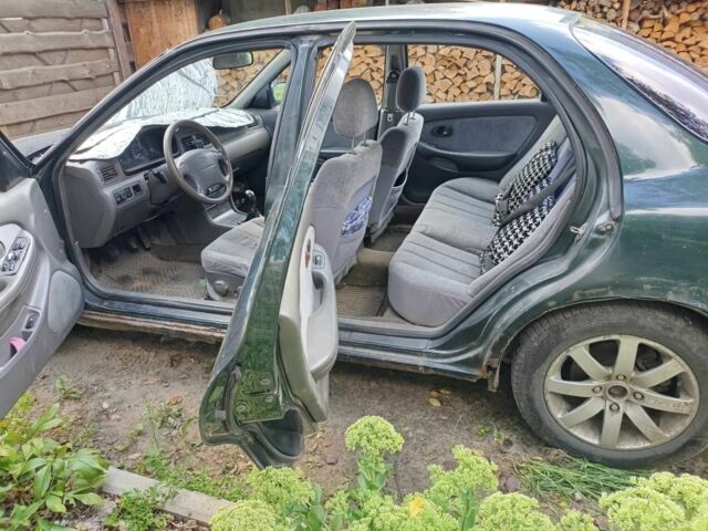 Зелений Кіа Кларус, об'ємом двигуна 2 л та пробігом 323 тис. км за 1000 $, фото 9 на Automoto.ua