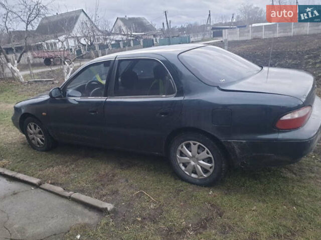 Зеленый Киа Кларус, объемом двигателя 1.8 л и пробегом 380 тыс. км за 1600 $, фото 2 на Automoto.ua