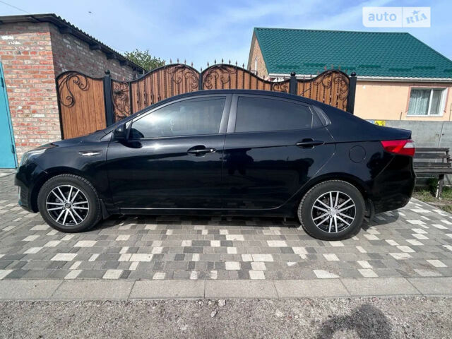 Чорний Кіа Ріо, об'ємом двигуна 1.4 л та пробігом 86 тис. км за 7400 $, фото 1 на Automoto.ua