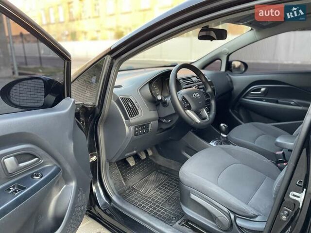 Чорний Кіа Ріо, об'ємом двигуна 1.4 л та пробігом 95 тис. км за 8999 $, фото 10 на Automoto.ua
