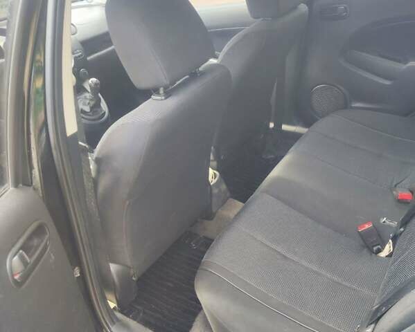 Черный Мазда 2, объемом двигателя 1.4 л и пробегом 195 тыс. км за 4900 $, фото 1 на Automoto.ua