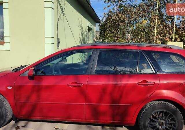 Красный Мазда 2, объемом двигателя 2 л и пробегом 265 тыс. км за 3650 $, фото 1 на Automoto.ua