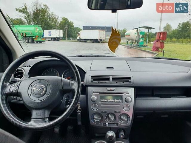 Червоний Мазда 2, об'ємом двигуна 1.4 л та пробігом 170 тис. км за 4200 $, фото 1 на Automoto.ua